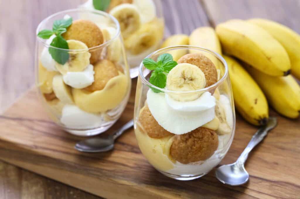 Banana cream pudding with coookies. Two portions served on a wooden table