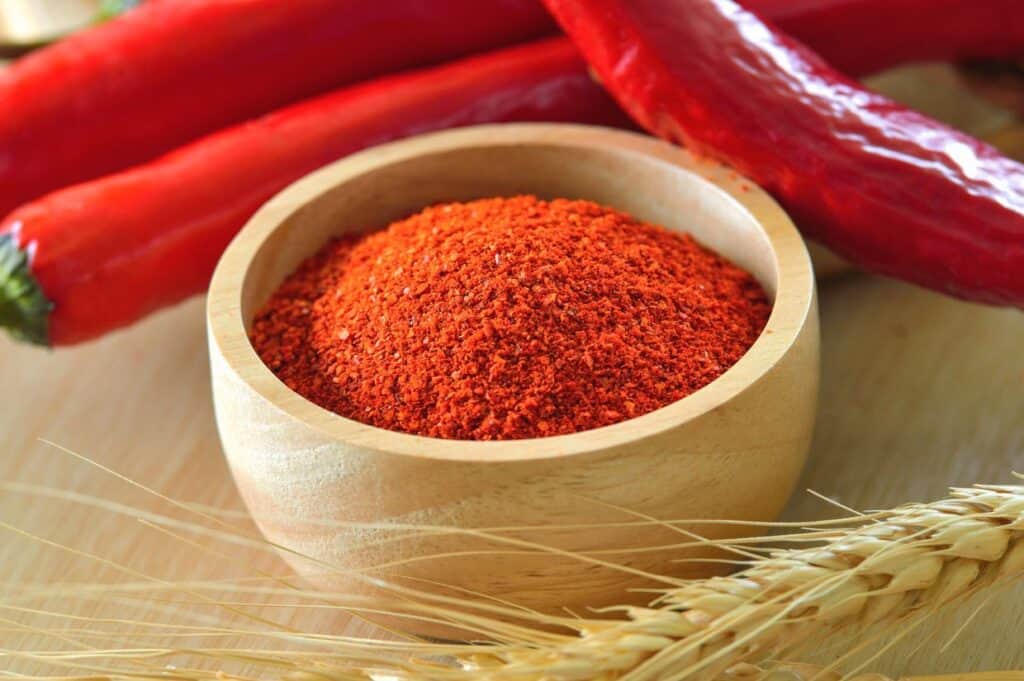 Cayenne pepper in wood bowl.