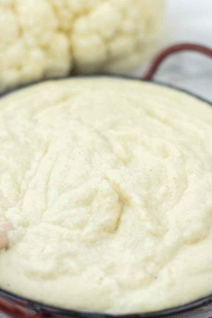 A close-up of creamy mashed cauliflower in a bowl.