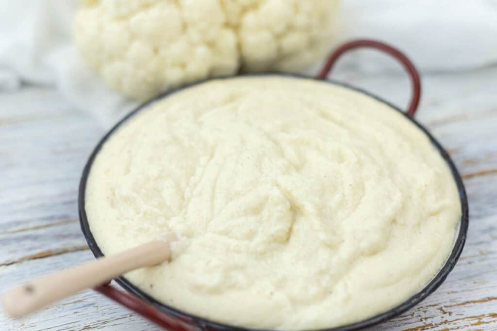 a bowl filled with creamy mashed cauliflower.