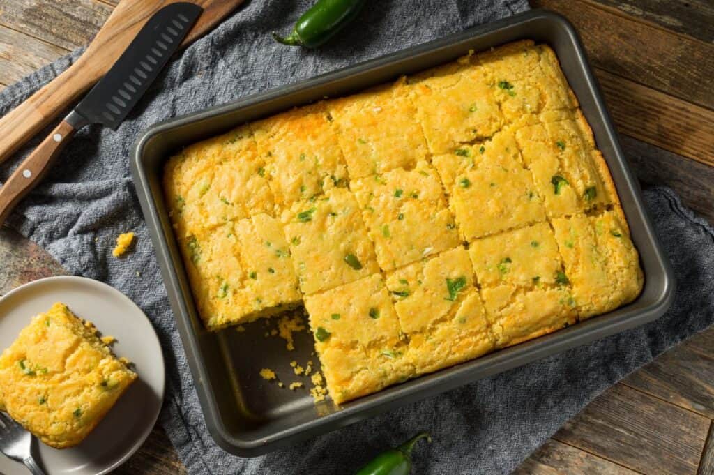 Homemade spicy jalapeno cornbread cut into squares.