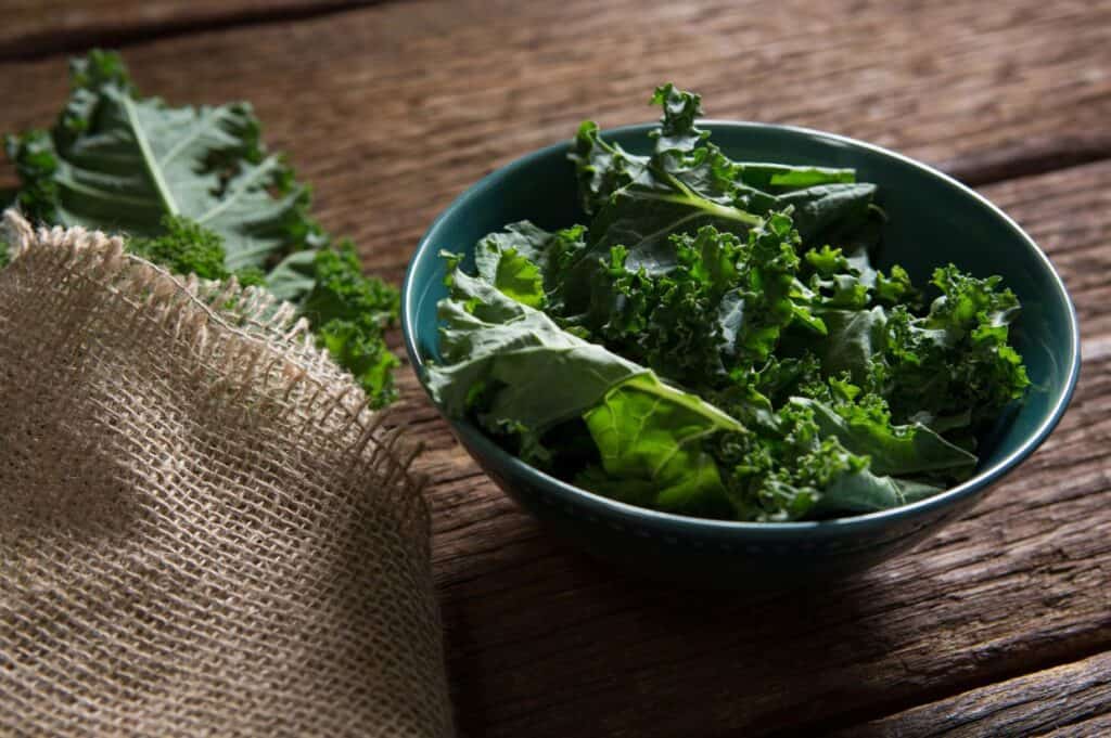 Mustard greens on wooden table.