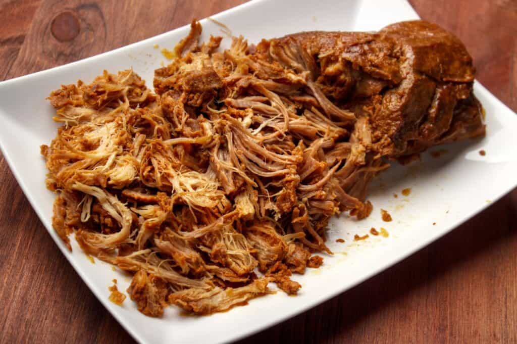 Pulled pork in a white plate.