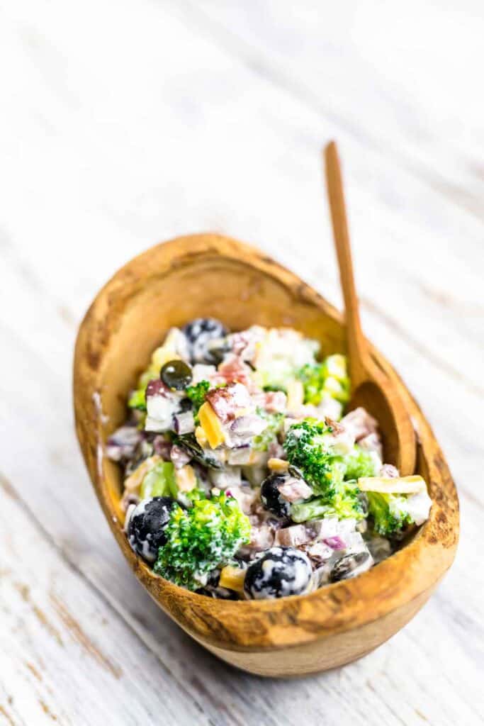 Southern-style broccoli serve in a bowl with a white wooden background.