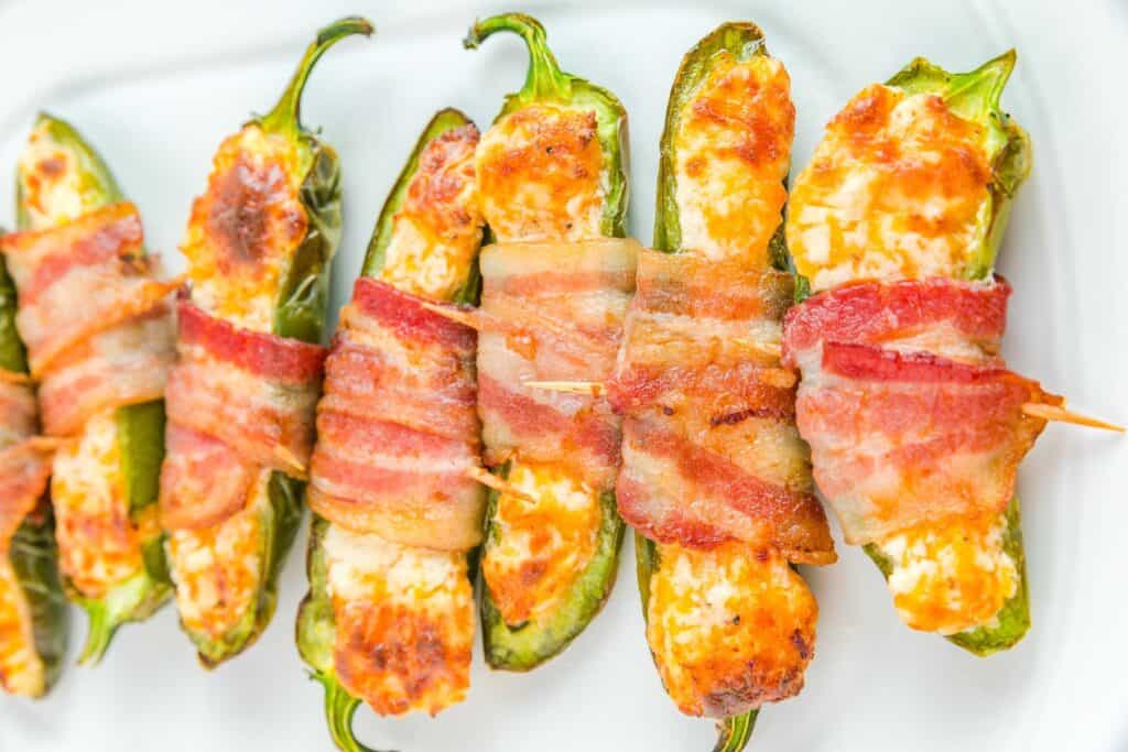 Close-up of Jalapeño poppers fresh from the air fryer, stuffed with cheese and bacon.