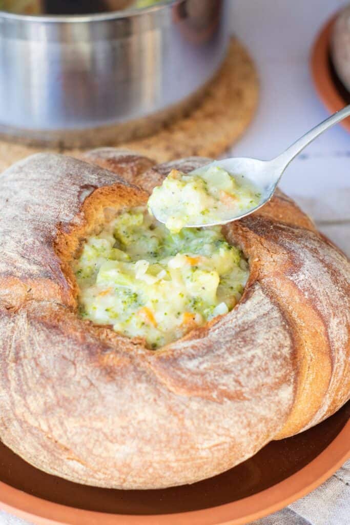 Creamy broccoli cheddar soup served in round bread bowls.