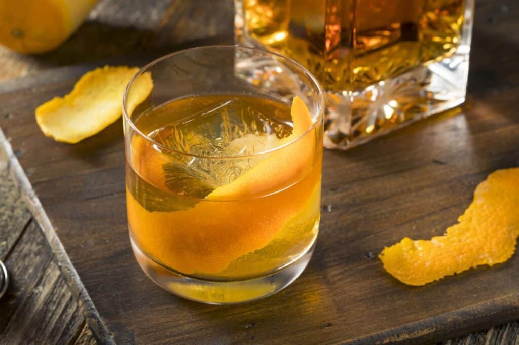 Cold alcoholic old fashioned bourbon whiskey cocktail.