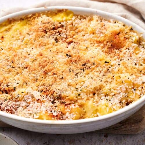 A serving of funeral potatoes with melted cheese and crispy edges.