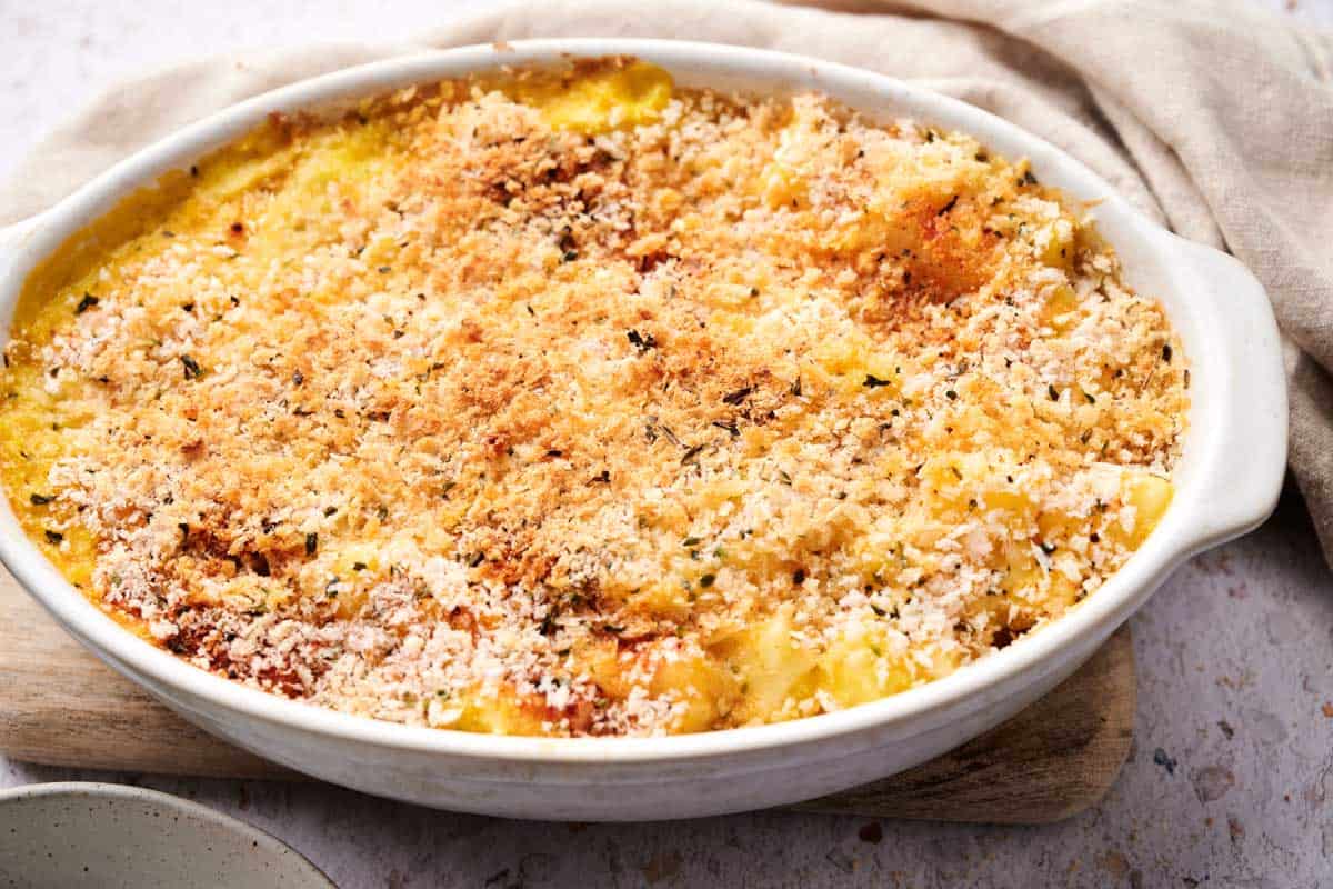 A serving of funeral potatoes with melted cheese and crispy edges.