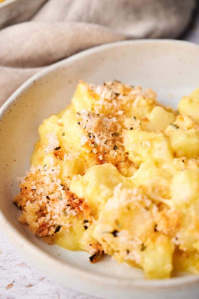 Funeral potatoes casserole topped with golden, crispy crumbs.