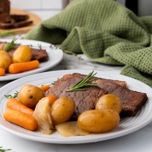 A Crockpot full of savory rump roast with vegetables, ready to be served for dinner.