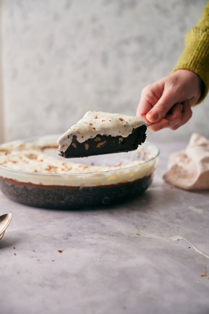 Decadent Mississippi Mud Pie topped with whipped cream.