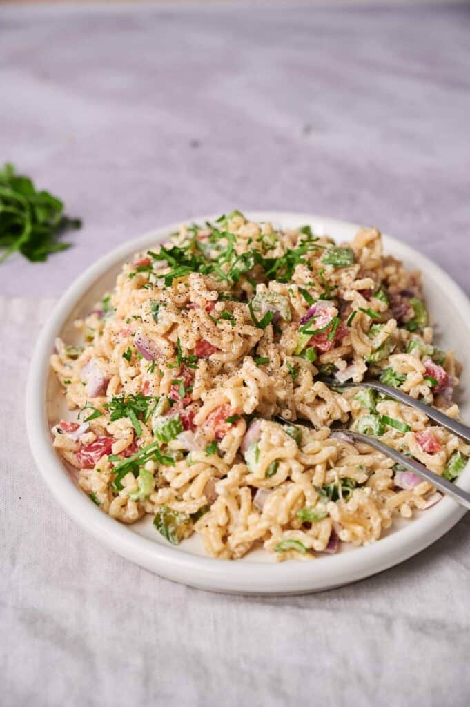 A serving of macaroni salad with creamy sauce.