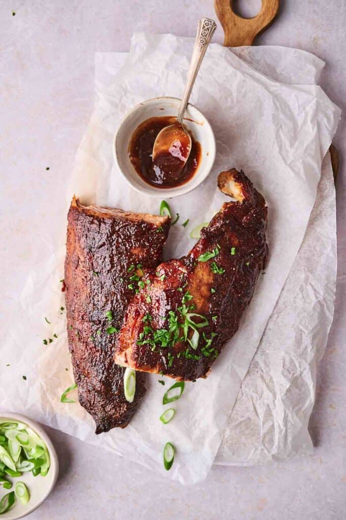 Oven-baked ribs brushed with barbecue sauce.