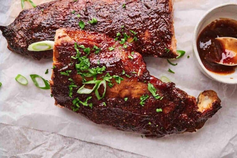 Oven-baked ribs served with fresh herbs.