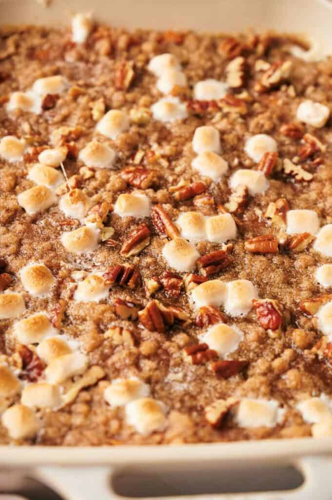 Golden sweet potato casserole topped with toasted marshmallows and pecans.