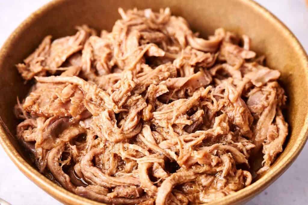 Tender pulled pork in a bowl.