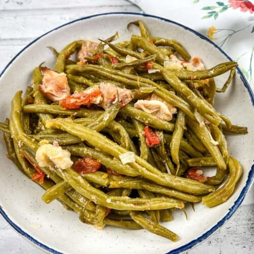 Slow Cooker Southern green beans in a white bowl with floral napkin.