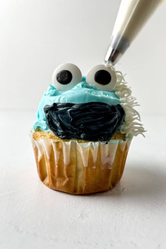 Abominable Snowman cupcakes with snowy frosting and a playful, monster-like face made of candy.