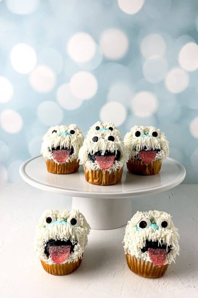 Cute Abominable Snowman cupcakes decorated with white frosting, candy eyes for a frosty look.