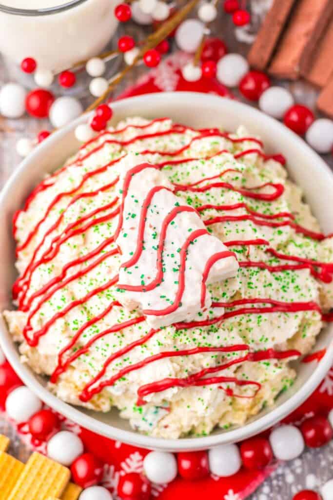 Close-up of a creamy Christmas tree cake dip in a white bowl.