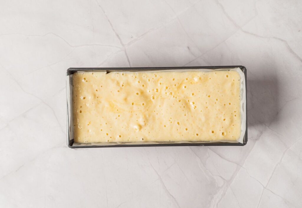 Poured cake batter into a lined pan.