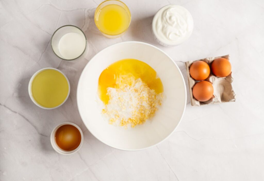 Beaten egg into the bowl of zest-sugar mixture.