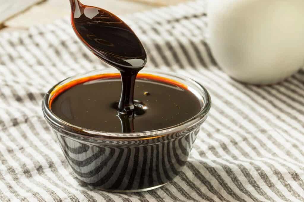 Organic black cane sugar molasses in a bowl.