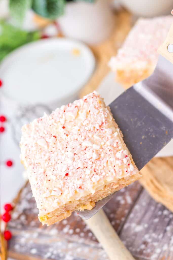 Close-up of peppermint sugar cookie bars topped with crushed candy canes.