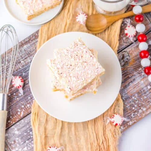 A festive display of peppermint sugar cookie bars surrounded by Christmas decorations.