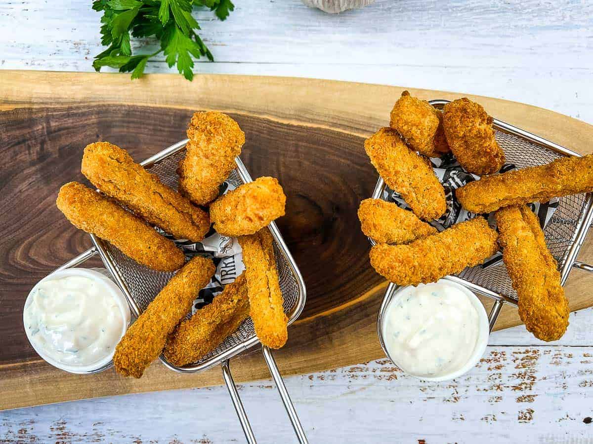 Crispy Air Fryer Chicken Fries served in two small baskets, accompanied by a side of dipping sauce.