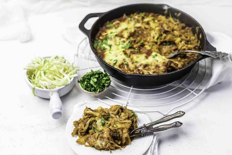 Beef casserole skillet with cabbage sides.