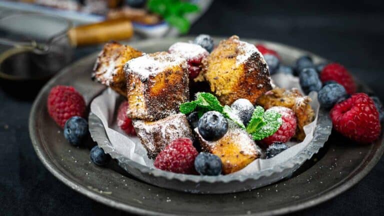 Brioche cubes and berries in a platter.