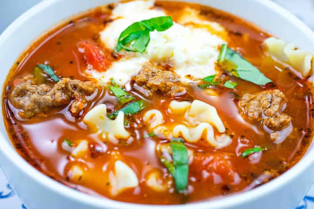 Bowl of lasagna soup and a dollop of cheese on top.