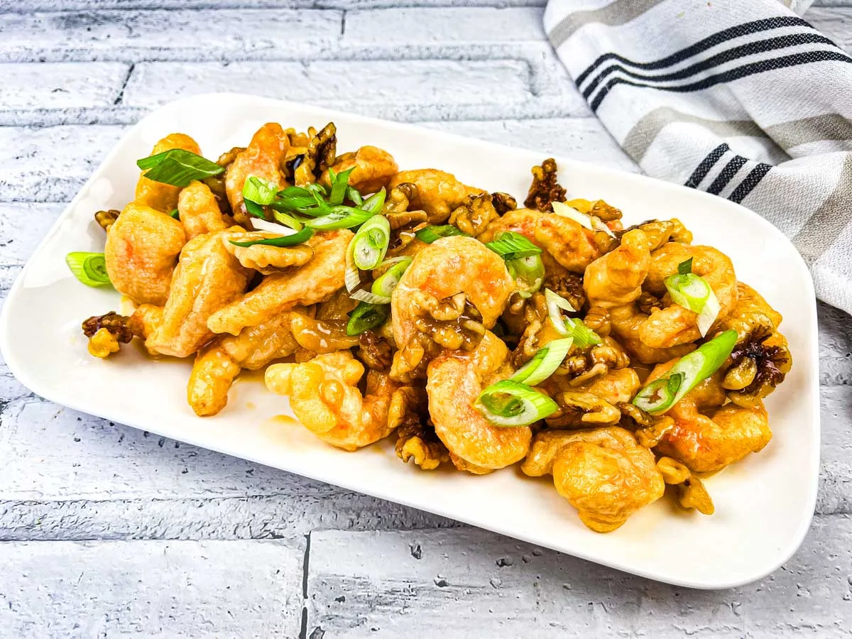 A plate of Copycat Panda Express Honey Walnut Shrimp served on a white rectangular dish.