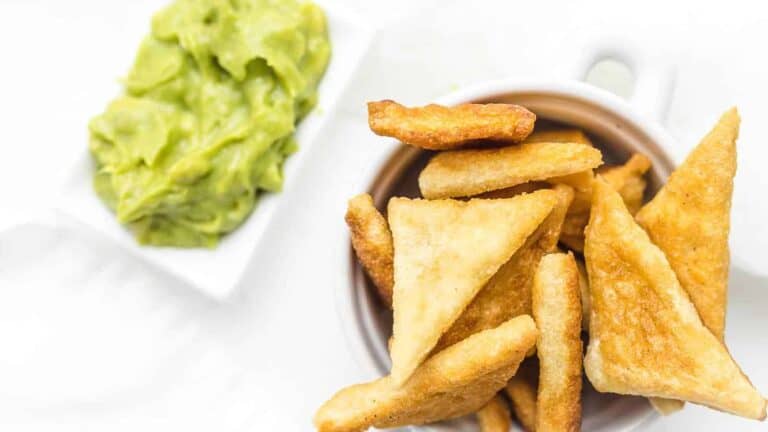 Keto Tortilla Chips with guacamole behind.