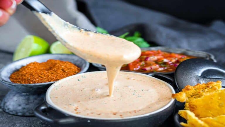 Easy Healthy Creamy Salsa Dressing in a dish with a spoon dishing it up.