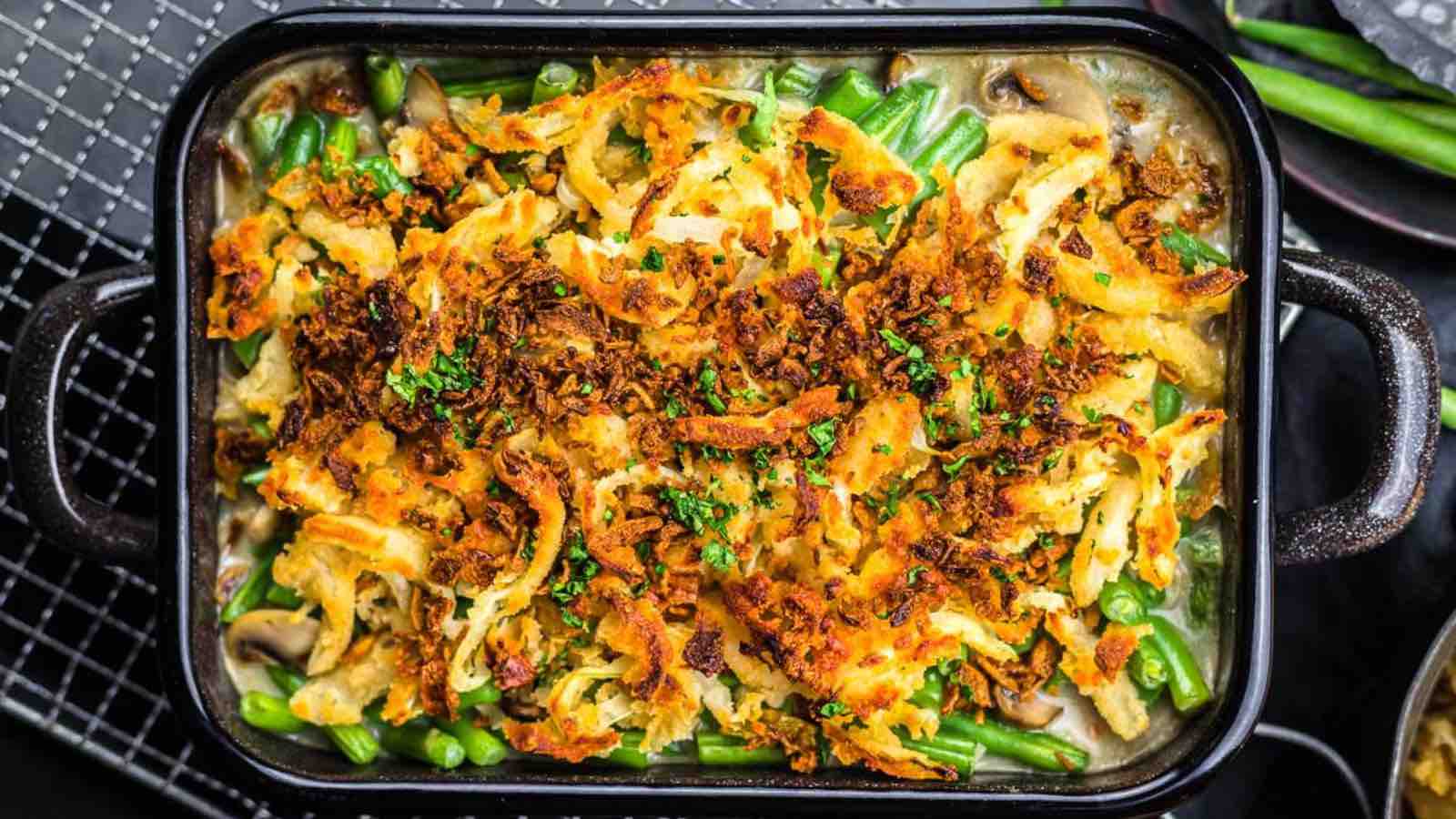 A baked green bean casserole topped with crispy fried onions.