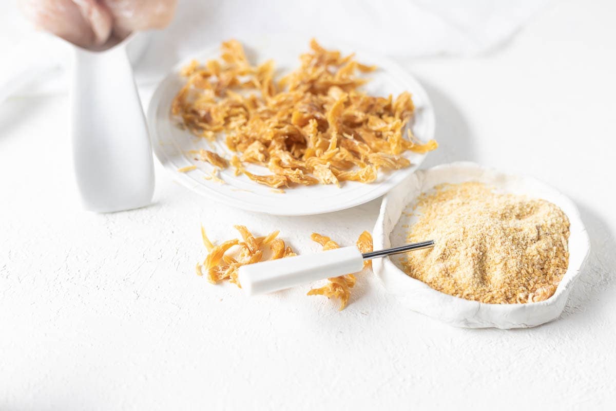 A plate with dried chicken and powdered chicken.