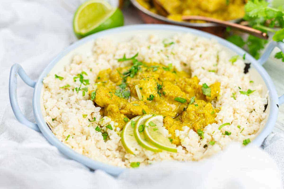 Creamy chicken curry over rice with lime.