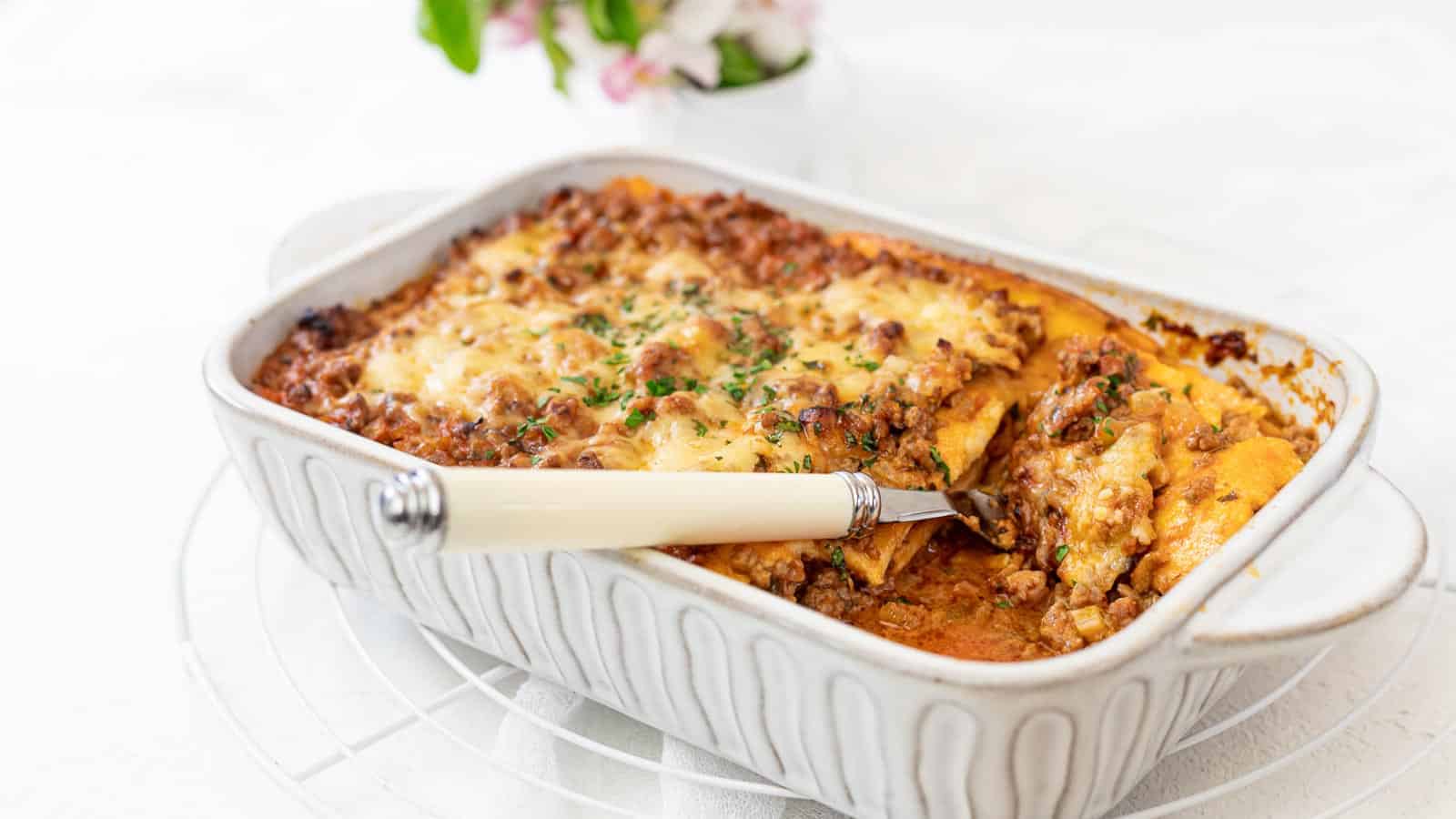 Low Carb Lasagna with Ground Beef in a rectangular dish with a fork.