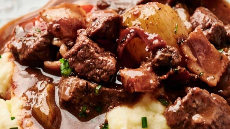 Beef Bourguignon served over creamy mashed potatoes.