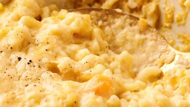 Close-up of a creamy macaroni and cheese dish with visible black pepper seasoning.