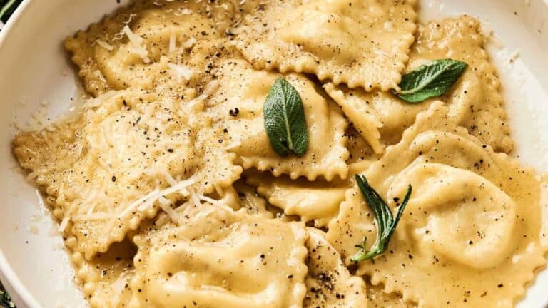 Cheese Ravioli on a white plate topped with black pepper.