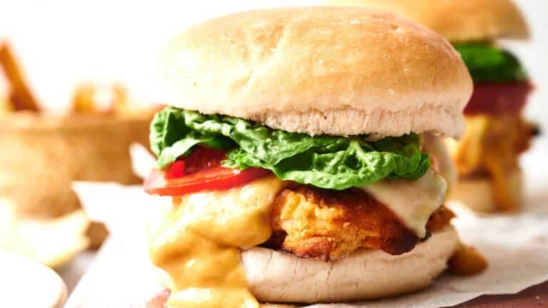 Homemade KFC Zinger Burger with lettuce, tomato, and sauce on a bun.