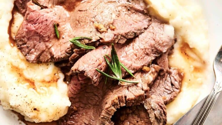 Roast Beef garnished with fresh rosemary.