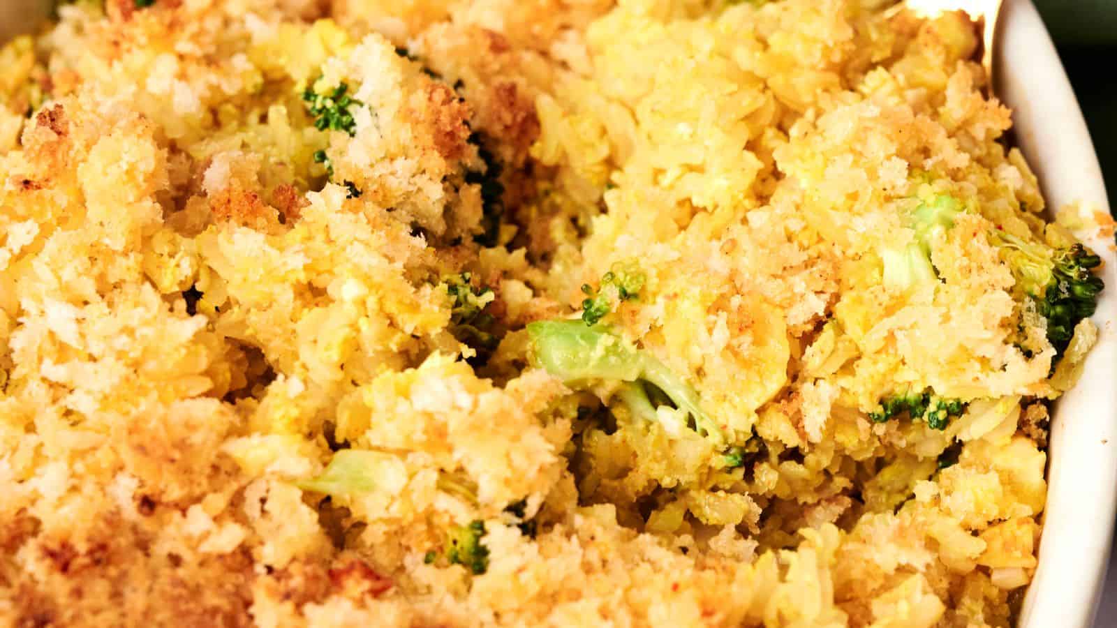 A casserole dish brimming with golden-brown bread crumbs, tender rice, and vibrant broccoli florets, this vegan cheesy broccoli and rice casserole is a delightful blend of flavors.