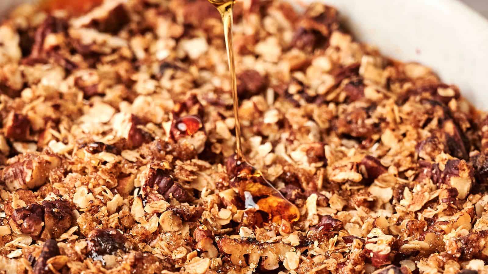 Granola with nuts and oats is drizzled with honey, creating a symphony of flavors reminiscent of a vegan sweet potato casserole.