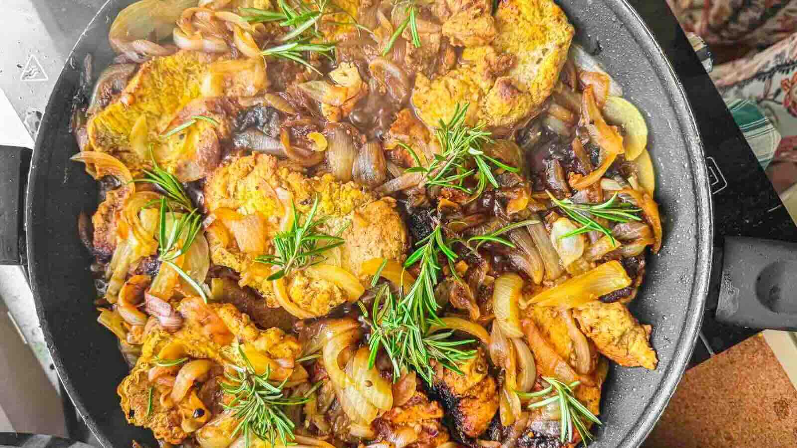 A pan filled with cooked pork pieces.