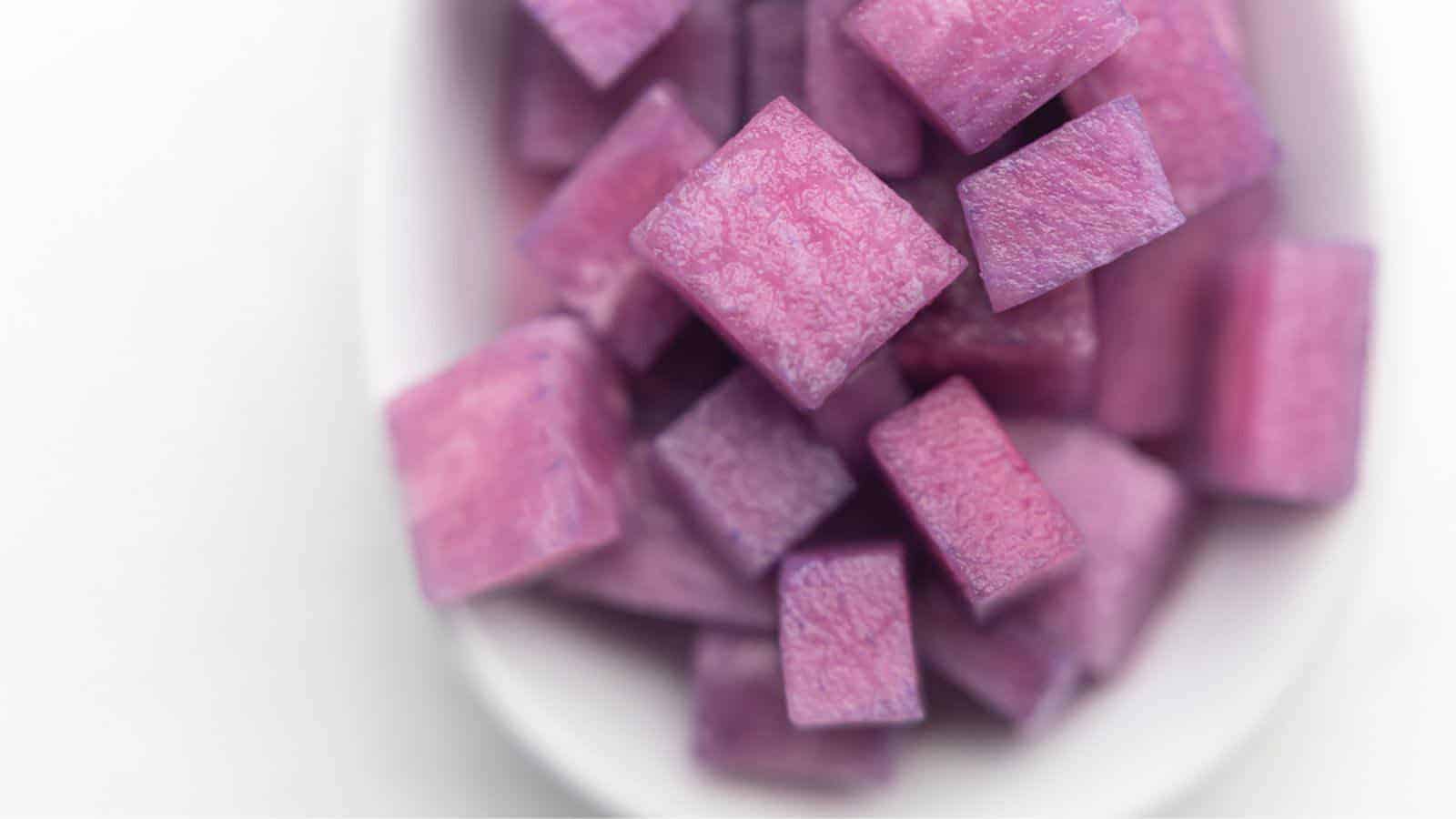 Purple daikon in a bowl on a white background.